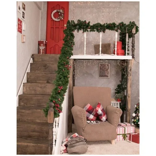Christmas interior of the house, the staircase is decorated with branches of the Christmas tree and Christmas toys. Red door, gifts. Festive mood, joy and happiness. A little magic. New Year